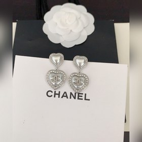 Новейшие серьги Chanel белого и золотистого цвета в форме сердца.